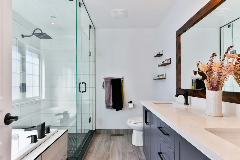 Remodeled modern bathroom with glass shower and vanity